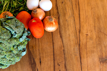 Wooden background with vegetables and flour. Top view.