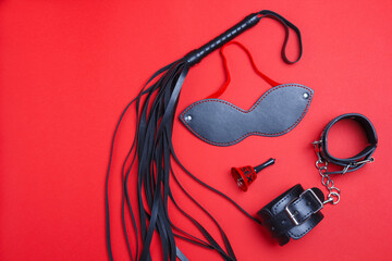 Whip and mask, bell and handcuffs for BDSM role-playing games. Sex shop is having fun as a...