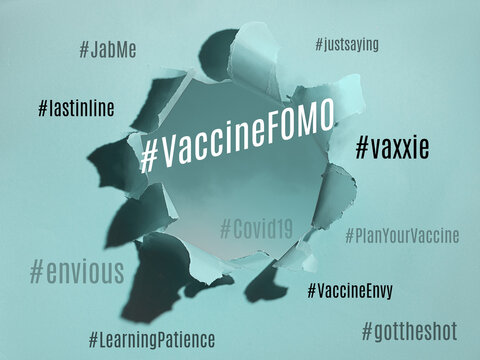 Vaccine FOMO Hashtag And Cloud Of Related Concepts On Paper Background. Fear Of Missing Out, Vaccine Envy. Uncertainty During Covid-19 Pandemics. Paper Hole With Text.