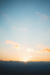 Sun peeking over the clouds during sunset