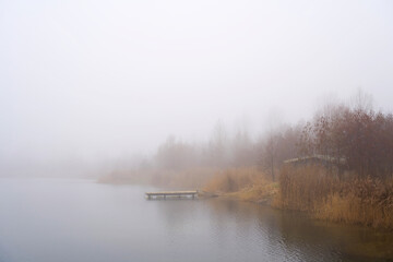  calm scene at a lonely lake near Magdeburg in Germany in fog 