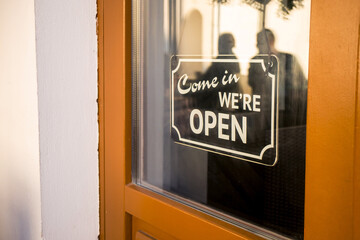 "Come in we are open" sign on the door