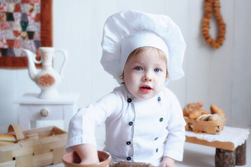 portrait of a little girl in baker clothes. choice of future profession