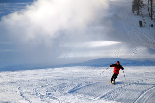 A skier takes his first run downhill in the morning
