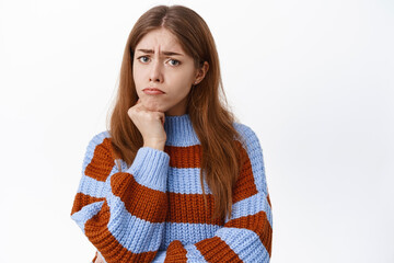 Sad displeased girl sulking, looking offended or insulted, being angry about unfair situation, staring disappointed, standing over white background