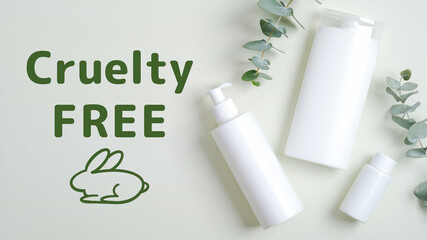 Natural organic cosmetics bottle containers and eucalyptus green leaves. Cruelty free cosmetics set on green background