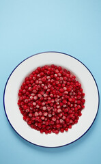 frozen red currants on wooden surface