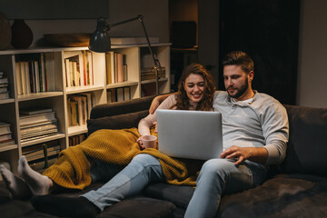 couple using laptop at home