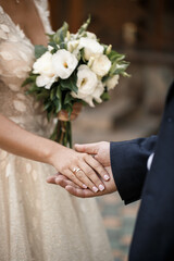 Obraz na płótnie Canvas Newlyweds on wedding day, wedding couple holding hands, bride and groom