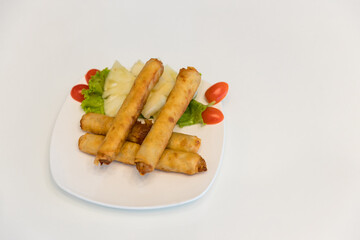Fried spring rolls with red and white sauces. Deep fried spring roll with sauce on white plate. Crispy spring rolls on dish with vegetable. Fried Chinese Traditional Spring rolls food.