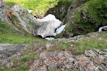 Waterfall from glacier in the mountains Alps