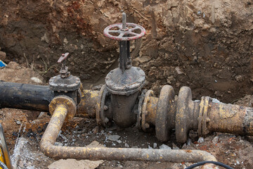 emergency services, the repair team provides safety during the replacement of pipes, old communications are changed to new ones, the gas pipeline, the old and rusted water pipe with dirty gates, repla