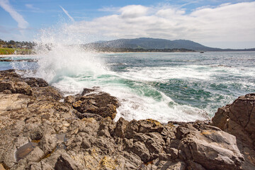 The Pacific Ocean coast in the city of Monterey in California. United States of America. Beautiful beach on a sunny day. Ocean landscape.