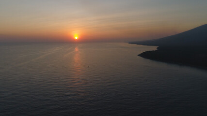 Fototapeta premium aerial view sunrise over ocean. seascape colorful sunrise over sea at tropical resort