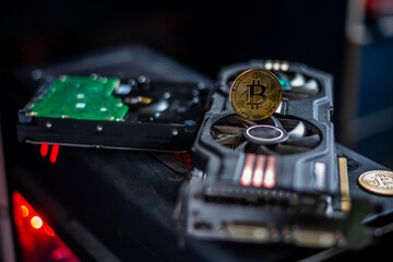 Fototapeta na wymiar Golden coins with bitcoin symbol on a graphics card