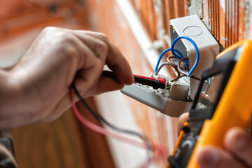 Electrician at work on a residential electrical system. Electricity.