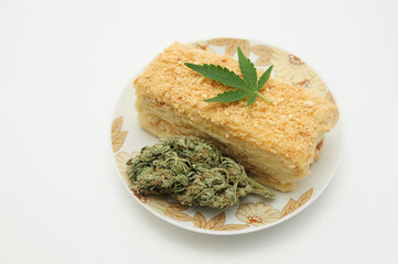 Puff cake with CBD oil and cannabis blooms isolated on white background. Marijuana kitchen.