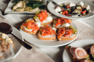 bruschettas with salmon and herbs in a plate on the table