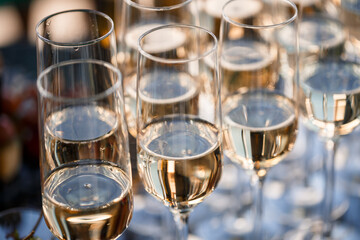 Glass goblets filled with sparkling champagne and stand on the table