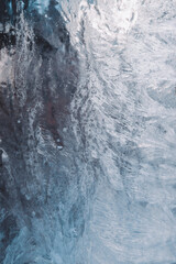Beautiful winter background, frost on the window, natural texture on glass with a frozen pattern. Copy space, natural background, macro
