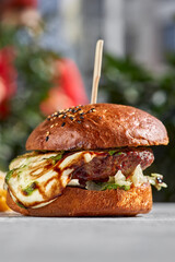 cheese burger with sunlight on stone background.