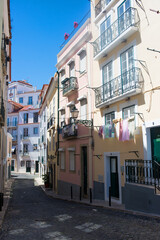 Fototapeta na wymiar Nice and colorful narrow street at Lisbon, Portugal, Europe