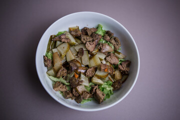 pear with chicken liver in a salad in the kitchen