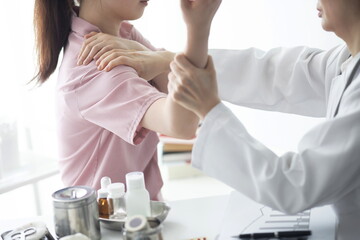 Doctor checking patient's arm pain