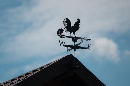 Weather vane on the roof of the house