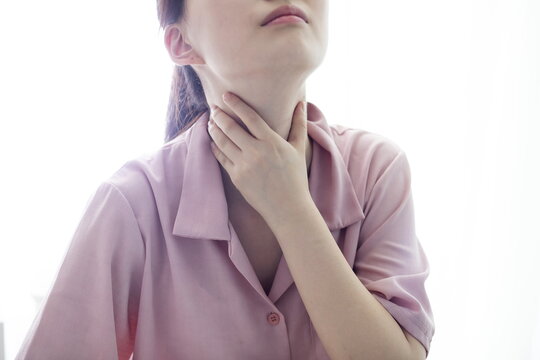Sore throat pain women. Woman hand touching neck with sore throat feeling bad. Healthcare and medicine concept