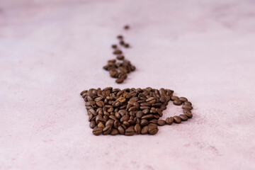 Coffee beans in the form of a cup of coffee with a copy of the space. Close-up. Space for text