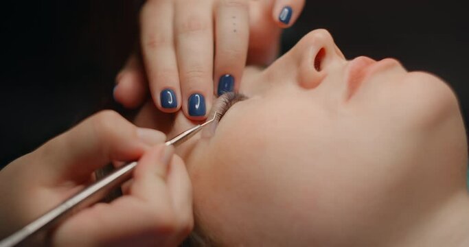 Lashmaker does the eyelash lamination procedure for the client in the beauty salon, cosmetic services, beauty care procedures, 4k 60p Prores HQ