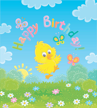 Birthday card with a happy little yellow chick dancing with small butterflies flittering over a pretty green lawn with colorful flowers on a sunny summer morning, vector cartoon illustration