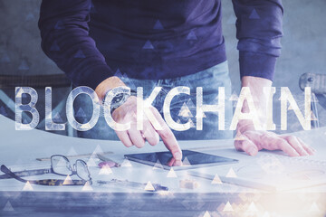 Double exposure of man's hands holding and using a phone and crypto currency blockchain theme drawing.