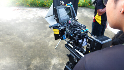 Behind the scenes video production at outdoor. film production on location. film crew team setting up camera and recording or shooting online movie. professional equipment for video production. © gnepphoto