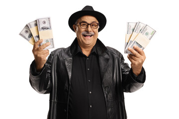 Elderly man in a leather coat and top hat holding bunch of money