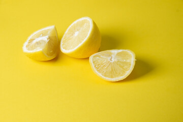 Fresh lemon sliced on a bright yellow background. Great combination with a yellow background. sour fruits.
