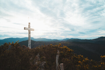 Christian cross on top of a mountain in Basque Country on a cloudy day