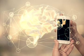 Double exposure of brain sketch hologram and woman holding and using a mobile device.