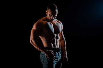 Fototapeta na wymiar Muscular man during workout in the gym