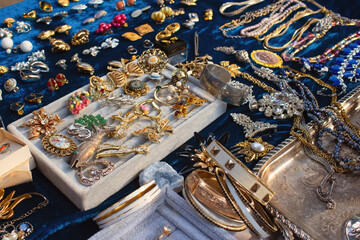 Antiques on flea market or seasonal festival - vintage jewelry, silver brooches and other vintage...