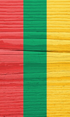 The flag of Lithuania on dry wooden surface, cracked with age. Vertical background, wallpaper or backdrop with Lithuanian national symbol. Light faded paint on old wood. Hard sunlight with shadows