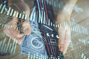 Multi exposure of Tech drawing hologram and USA dollars bills and man hands. Technology concept.