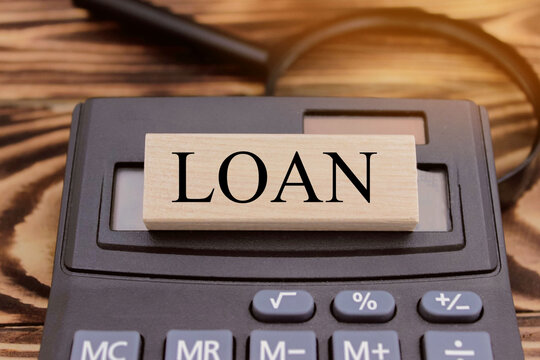 Cubes labeled "Loan". Calculator, money, crisis, business