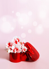Heart shape gift box and bouquet on pink background.