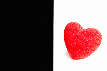 Red heart on black and white background. The heart is on the white color.
