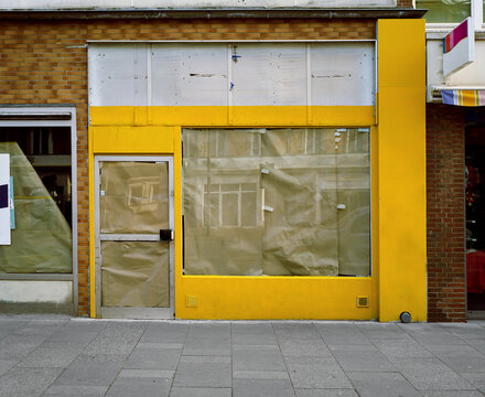 Closed And Locked Yellow Pawnshop, Impact Of The Corona Pandemic 2021 In Germany During Lockdown, Closed Small Business.