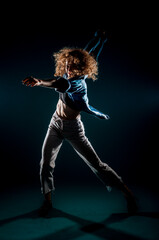 Fototapeta na wymiar Modern style dancer isolated on dark background