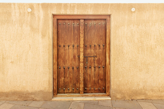 Antique wooden doors in an ancient sandstone town