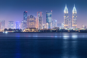 Fototapeta na wymiar Night sea view of the brightly lit Internet City area in Dubai. Concept of real estate investment and the cost of electricity for lighting